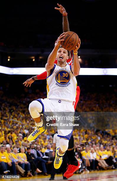 Stephen Curry of the Golden State Warriors goes up against Josh Smith of the Houston Rockets in the fourth quarter during Game One of the Western...