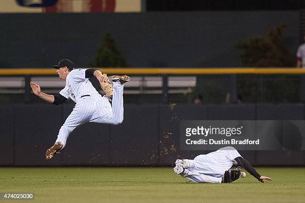 Drew Stubbs and DJ LeMahieu of the Colorado Rockies collide as a fly ball falls into center field in the 8th inning of a game against the...