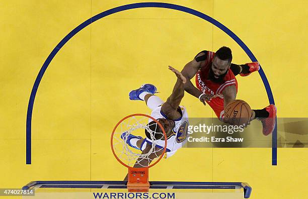 James Harden of the Houston Rockets shoots against Festus Ezeli of the Golden State Warriors in the second half during Game One of the Western...