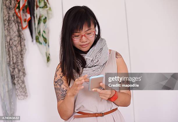 checking in with her girlfriends - tattooed asian women stock pictures, royalty-free photos & images
