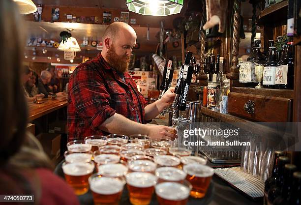 Tim Decker pours samples of Lagunitas Brewing Company beers during a brewery tour at Lagunitas Brewing Company on February 21, 2014 in Petaluma,...