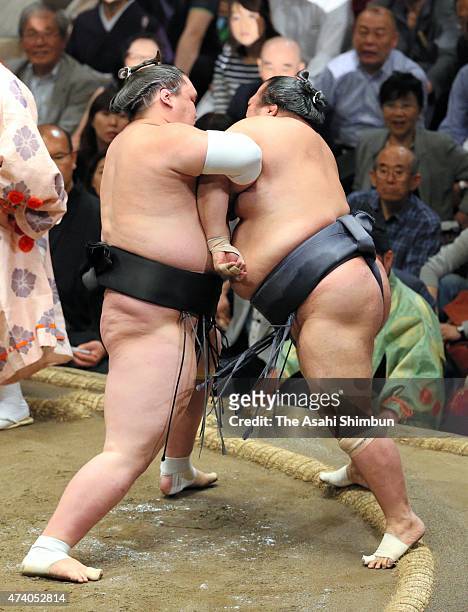 Mongolian sekiwake Terunofuji pushes Toyonoshima out of the ring to win during day ten of the Grand Sumo Summer Tournament at Ryogoku Kokugikan on...