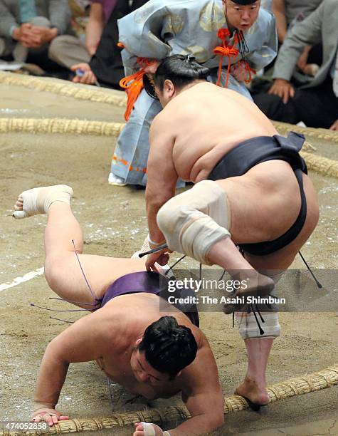 Aminishiki thorws Tochiozan to win during day ten of the Grand Sumo Summer Tournament at Ryogoku Kokugikan on May 19, 2015 in Tokyo, Japan.