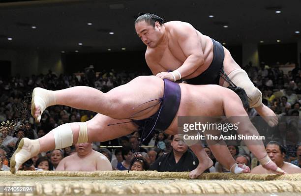Aminishiki thorws Tochiozan to win during day ten of the Grand Sumo Summer Tournament at Ryogoku Kokugikan on May 19, 2015 in Tokyo, Japan.