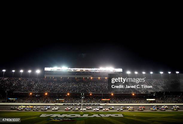 Ben Kennedy, driver of the Florida Lottery/Whelen Chevrolet, leads the field past the green flag to start the Camping World Truck Series NextEra...