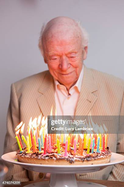 man enjoying 93 candles on a birthday cake - cake candles stock pictures, royalty-free photos & images