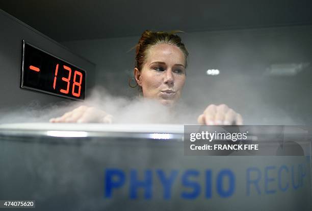 France's midfielder Amandine Henry reacts as she undergoes treatment in a medical device used for cryotherapy at the French national football team...