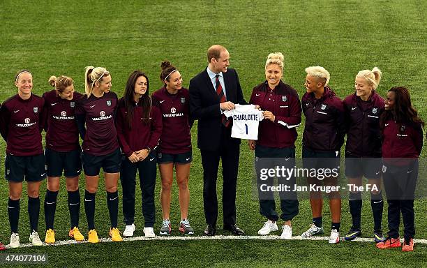 Prince William, Duke of Cambridge shares a joke with Captain Steph Houghton and the team after being presented with a gift during a visit to the...