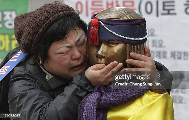 South Korean woman embraces the comfort women statue during an anti-Japan rally in front of the Japanese embassy on February 22, 2014 in Seoul, South...