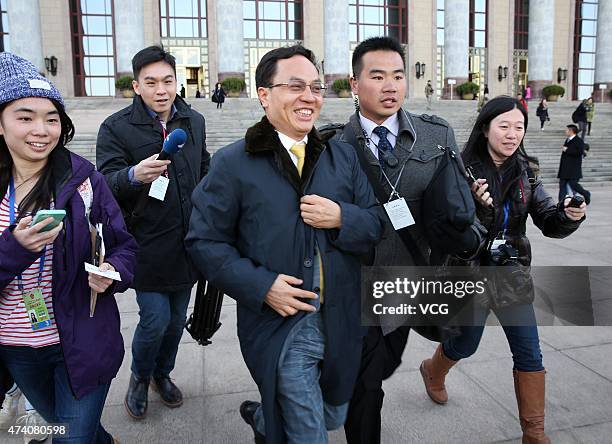 Li Hejun, Chairman of Hanergy Holding Group, walks out of the Great Hall of the People after a meeting of the Chinese People's Political Consultative...