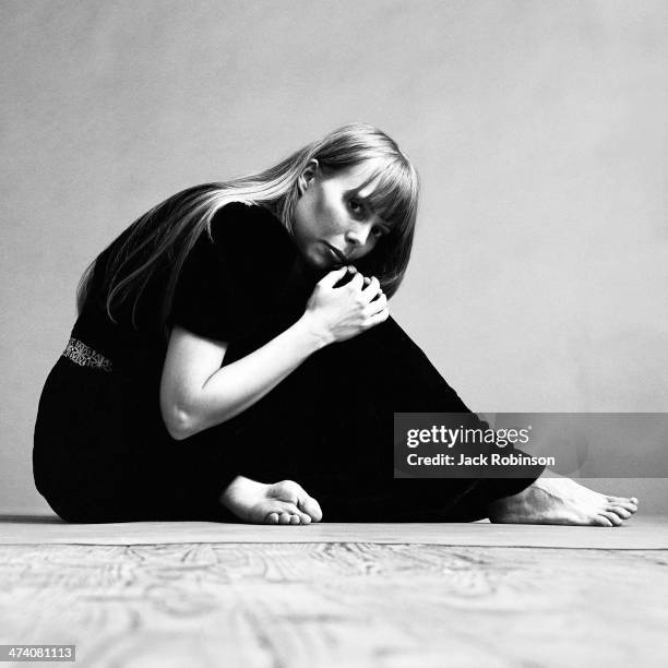 Portrait of Canadian musician Joni Mitchell wearing a black short-sleeved dress with several necklaces, November 1968. This image was from a photo...