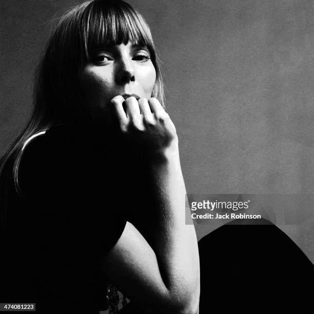 Portrait of Canadian musician Joni Mitchell wearing a black short-sleeved dress with several necklaces, November 1968. This image was from a photo...