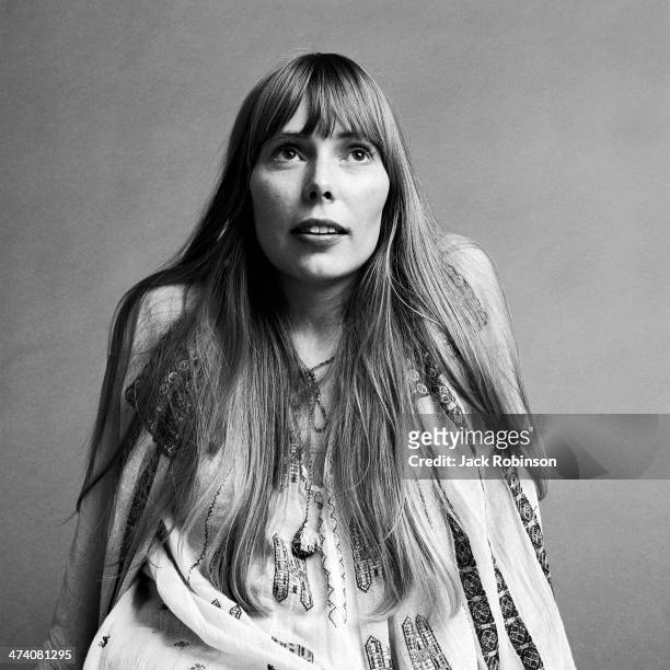 Portrait of Canadian musician Joni Mitchell wearing a loose-fitting white cotton dress, New York, November 1968. This image was from a photo shoot...