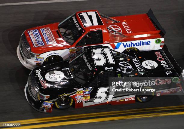 Kyle Busch, driver of the ToyotaCare Toyota, races Timothy Peters, driver of the Valvoline Toyota, during the Camping World Truck Series NextEra...