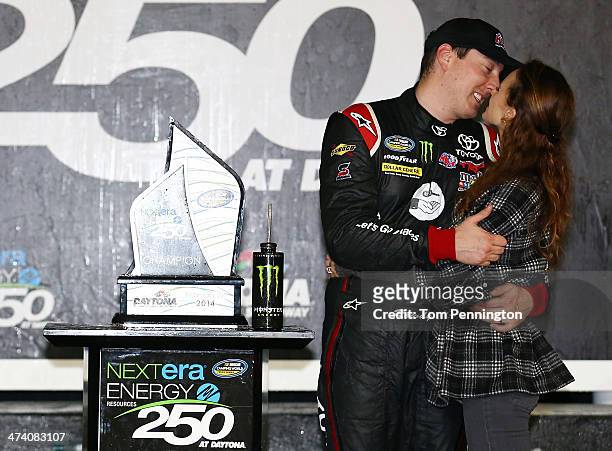 Kyle Busch, driver of the ToyotaCare Toyota, celebrates in Victory Lane with his wife Samantha after winning during the Camping World Truck Series...
