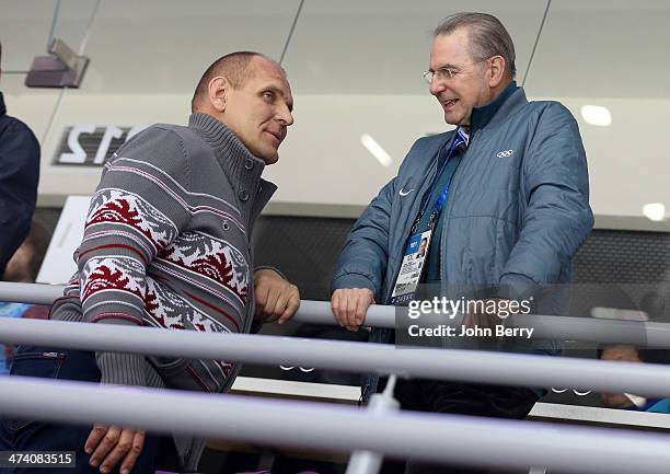 Olympian Alexander Karelin of Russia and Jacques Rogge, former IOC President attend the Men's Ice Hockey Semifinal Playoff between Sweden and Finland...