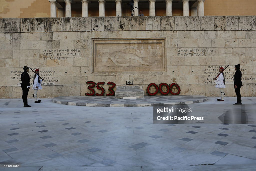 Four Evzones (Greek Presidential Guard), two dressed in the...