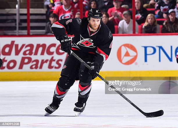 Tim Gleason of the Carolina Hurricanes brings the puck up ice against the Washington Capitals during an NHL game on February 27, 2015 at PNC Arena in...