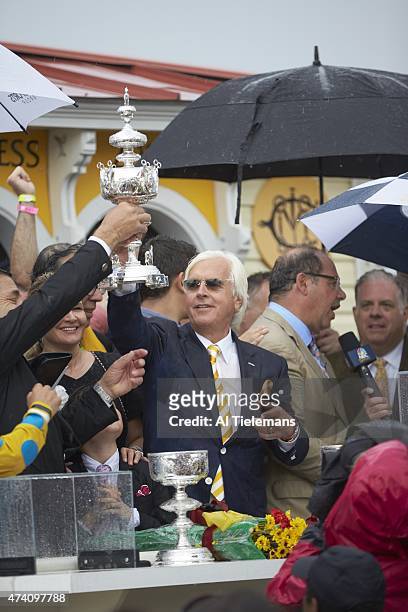 140th Preakness Stakes: Bob Baffert, trainer of American Pharoah, victorious with Woodlawn Vase trophy in Winner's Circle after winning race at...