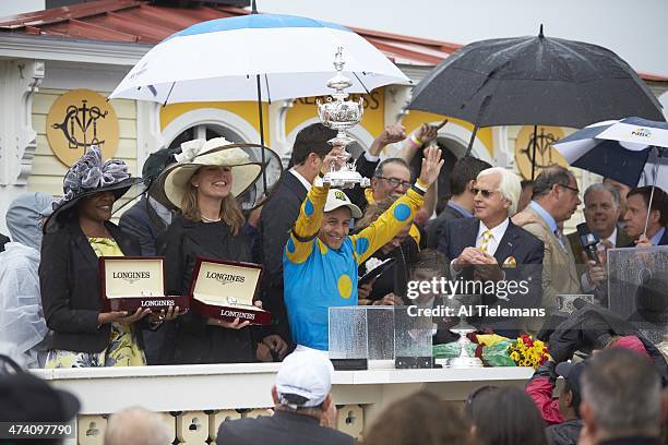 140th Preakness Stakes: Victor Espinoza, jockey for American Pharoah, victorious with Woodlawn Vase trophy in Winner's Circle after winning race at...