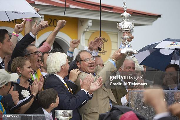 140th Preakness Stakes: Ahmed Zayat , owner of American Pharoah, victorious, holding Woodlawn Vase trophy with trainer Bob Baffert in Winner's Circle...