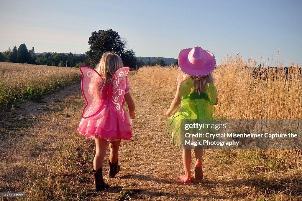 Girls in dress up clothes walking on country road