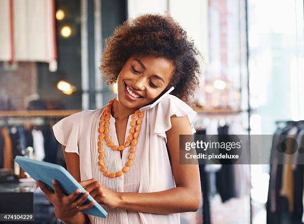 woman using a digital tablet and talking on phone - multitasking business stock pictures, royalty-free photos & images