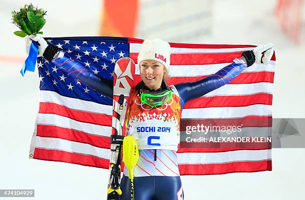 Gold medallist US skier Mikaela Shiffrin poses with the stars and stripes on the podium during the Women's Alpine Skiing Slalom Flower Ceremony at...