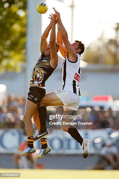 Brandon Ellis of Richmond and Quinten Lynch of Collingwood compete for the ball during the NAB challenge match between the Collingwood Magpies and...