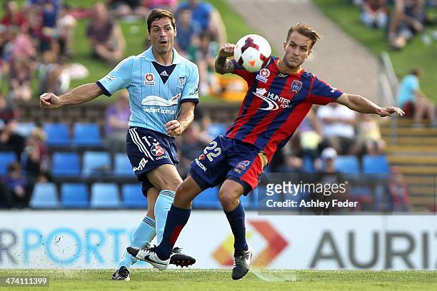 Adam Taggart of the Jets contests the ball against Sasa Ognenovski of Sydney FC during the round 20 A-League match between Newcastle Jets v Sydney FC...