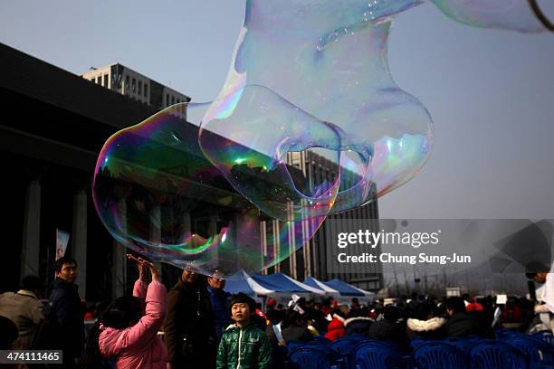 An artist blows a soap bubble as people attend anti-Japan rally on February 22, 2014 in Seoul, South Korea. South Korea and Japan are making claim to...