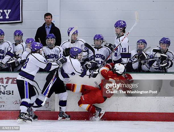 Gonzaga's Mackie Wheeler, left, and Bobby Hally, center, combine to push Calvert Hall's Jack Finn off the puck during the MAPHL Championship game...