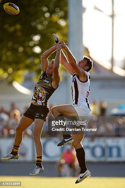 Brandon Ellis of Richmond and Quinten Lynch of Collingwood compete for the ball during the NAB challenge match between the Collingwood Magpies and...