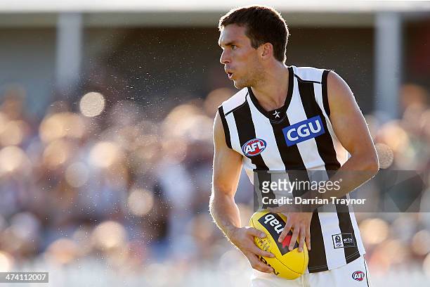Clinton Young of Collingwood runs with the ball during the NAB challenge match between the Collingwood Magpies and the Richmond Tigers on February...
