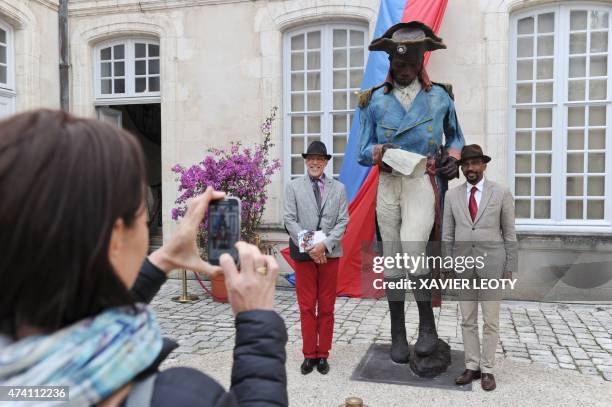 Visitors take pictures with the sculpture of Toussaint Louverture , an Haitian revolutionary and separist general who died in captivity in France,...