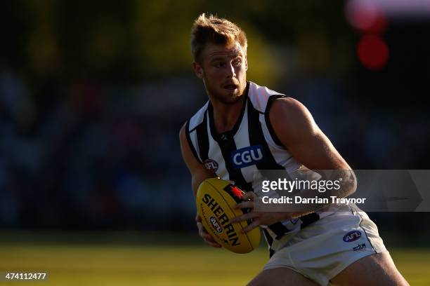 Jonathon Marsh of Collingwood runs with the ball during the NAB challenge match between the Collingwood Magpies and the Richmond Tigers on February...