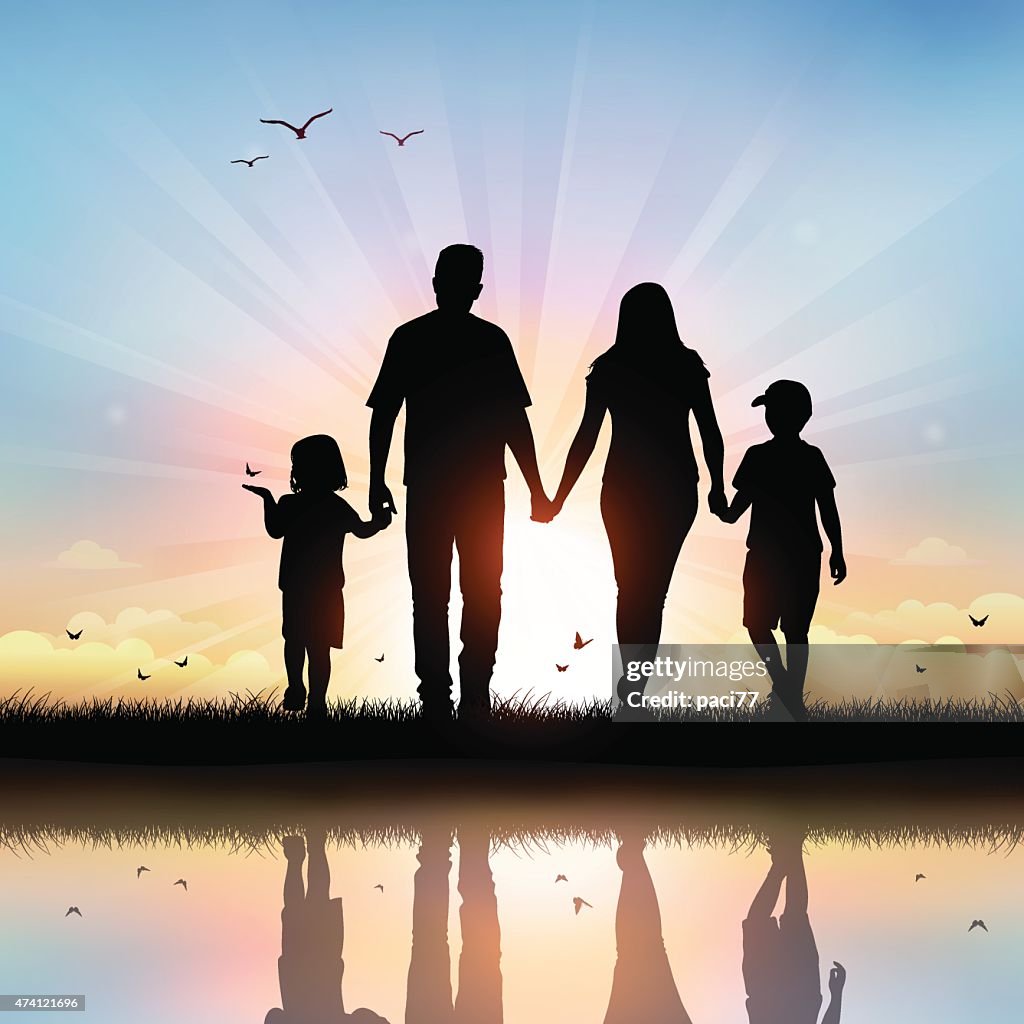 Happy Family with children walking at sunset time