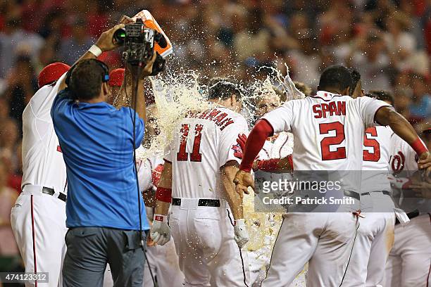 Ryan Zimmerman of the Washington Nationals is greeted at home plate by teammates after hitting a two run walk-off home run in the tenth inning...