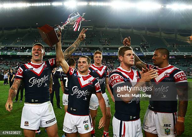 Daniel Mortimer of the Roosters holds aloft the World Club Challenge trophy after the NRL World Club Challenge match between the Sydney Roosters and...