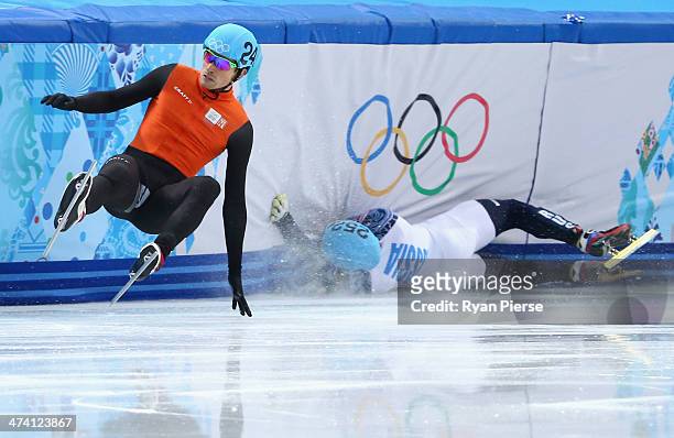 Vladimir Grigorev of Russia hits the wall while Freek van der Wart of the Netherlands falls in the Short Track Men's 500m Quarterfinals on day...