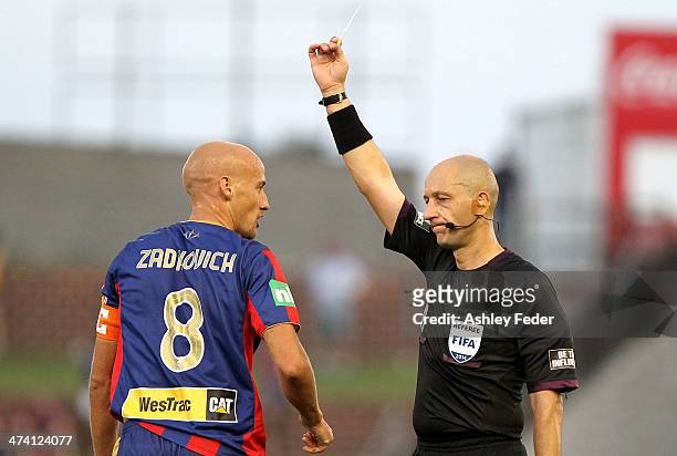 Ruben Zadkovich receives a yellow card during the round 20 A-League match between Newcastle Jets v Sydney FC at Hunter Stadium on February 22, 2014...