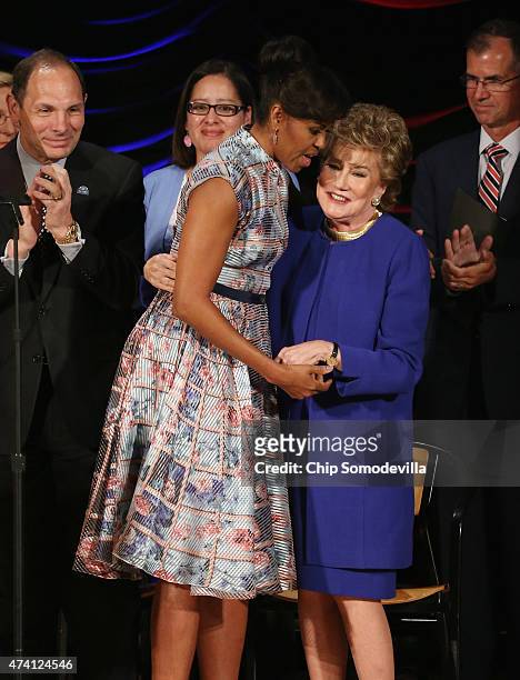 First lady Michelle Obama embraces former Sen. Elizabeth Dole with Veterans Affairs Secretary Robert McDonald during the Elizabeth Dole FoundationÕs...