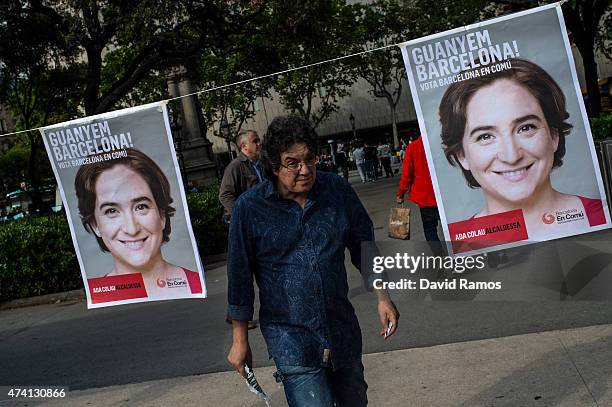 Man walks amongst posters of political party 'Barcelona en Comu' Leader Ada Colau during a Municipal Elections rally on May 20, 2015 in Barcelona,...