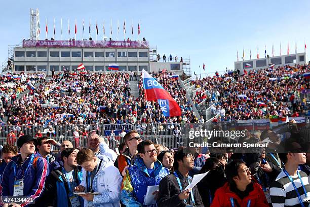 Spectators show their support in the Snowboard Men's and Ladies' Parallel Slalom Finals on day 15 of the 2014 Winter Olympics at Rosa Khutor Extreme...