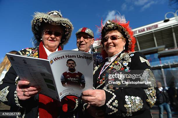 Pearly Kings and Queens read the match day programme during the Barclays Premier League match between West Ham United and Southampton at Boleyn...