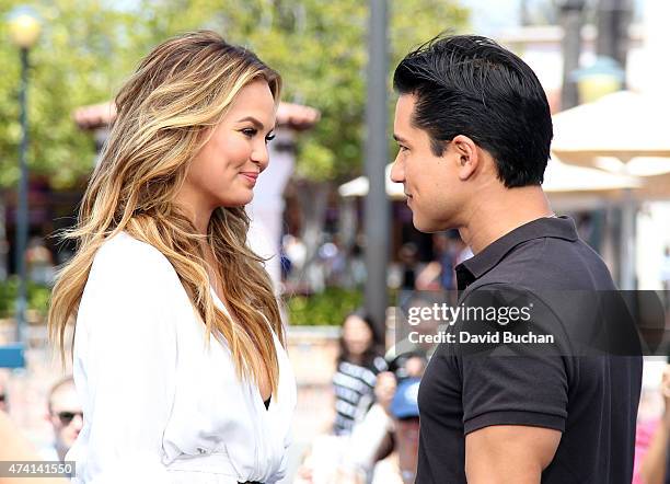 Model Chrissy Teigen visits Mario Lopez on the set of "Extra" at Universal Studios Hollywood on May 20, 2015 in Universal City, California.