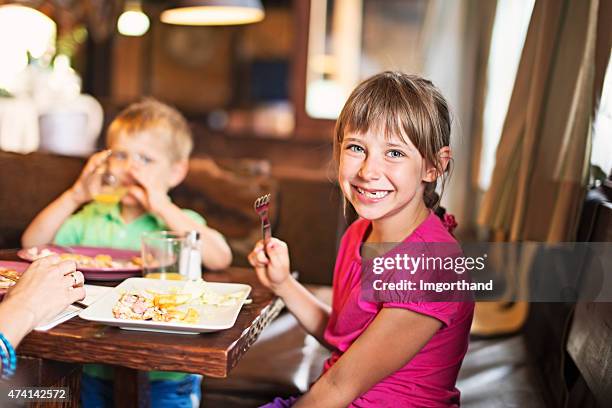 family enjoying dinner - restaurant kids stockfoto's en -beelden