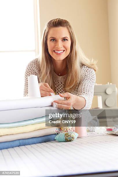 female dressmaker working in her studio - woman measuring tape stock pictures, royalty-free photos & images