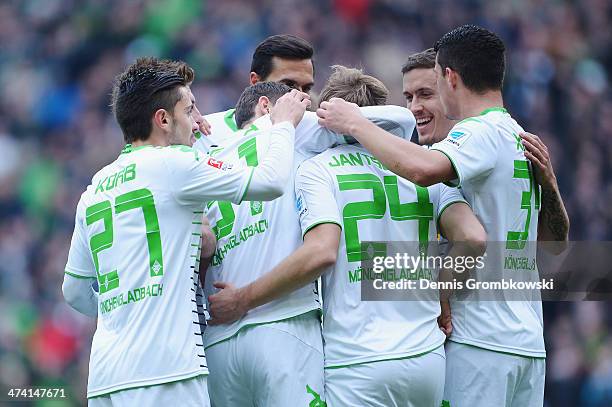 Tony Jantschke of Borussia Moenchengladbach celebrates with teammates after heading his team's second goal during the Bundesliga match between...