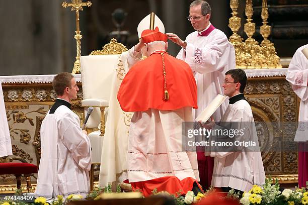 New German Cardinal, Gerhard Ludwig Muller receives his biretta cap from Pope Francis during the Consistory at St Peter's Basilica on February 22,...